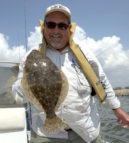 flounder fisherman holding flounder