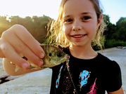 Young girl holding fish