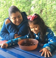 Mom and Daughter looking at worms