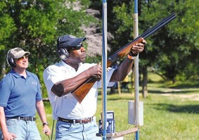 person shooting clays with instructor
