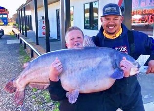 Brayden holding 67 lb blue catfish, video link