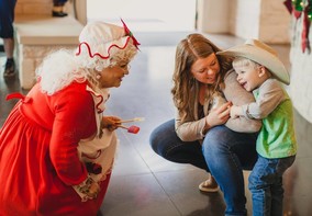 Mrs. Claus and cowboy kid