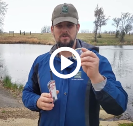 biologist holding trout fishing gear, video playbutton
