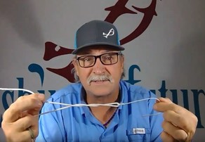 Michael Scherer demonstrating how to tie a fishing knot