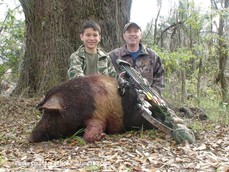 adult and child with hog