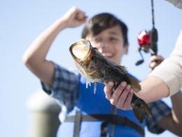 Happy boy caught a largemouth bass