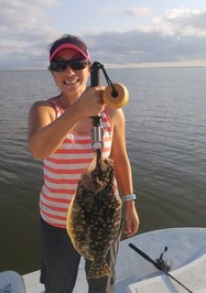 Woman angler holds flounder