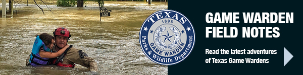Game Warden carrying child in flood water, link 