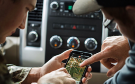 2 men looking at the onX app on a phone