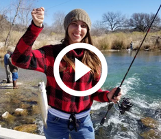 woman holding rainbow trout, video link