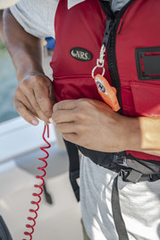 Engine cut off switch attached to a life jacket