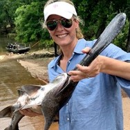 woman holding paddlefish, link to webinar