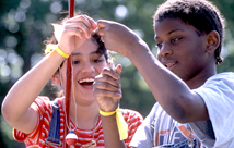 A boy and girl baiting a fishing hook