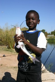 Young boy holding a catfish