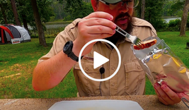 Ranger John putting food in a foil envelope, video link