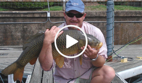 Angler holding carp, link to video