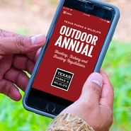 Image of a hunter holding a smart phone displaying the Outdoor Annual mobile app home screen