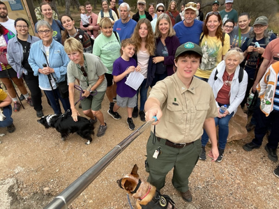 Image of a ranger taking a group selfie 