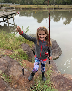 Picture of a young girl who just caught a fish