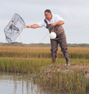 A man throwing a casting net