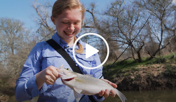 happy girl holding white bass, video link