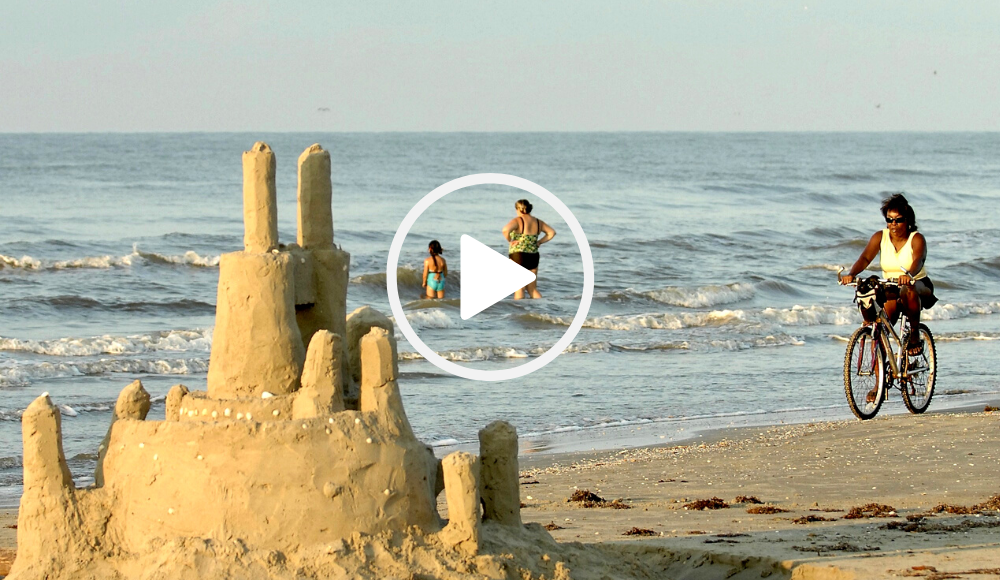 Galveston Island SP beach with sandcastle and cyclist, video link 