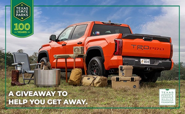 Image of a Toyota truck surrounded by camping gear.