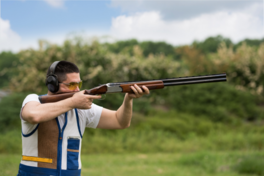 Image of a man aiming a shotgun.