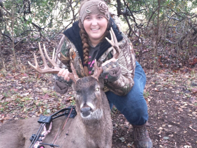 female bowhunter with buck harvest