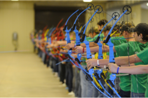 Image of students in a line aiming bows
