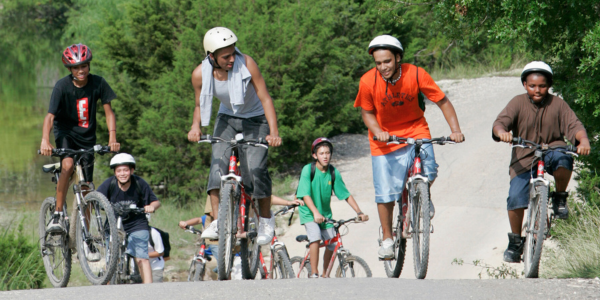 A group of kids biking in a park.