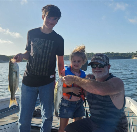 Picture of a happy family fishing and showing their catch