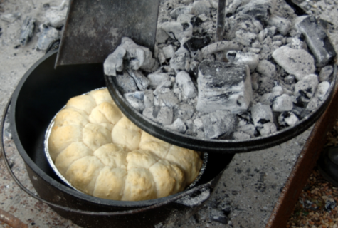 Cheesy biscuits in a Dutch oven, top filled with coals, video link