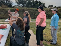 Female instructor demonstrates shooting