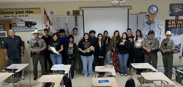 Instructor posing with Game wardens and students in class