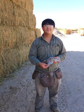 Hunter holding his first game harvest