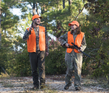 2 deer hunters walking on road