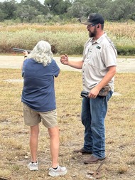 Woman shooting shotgun