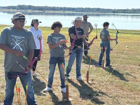 Kids shooting archery outside