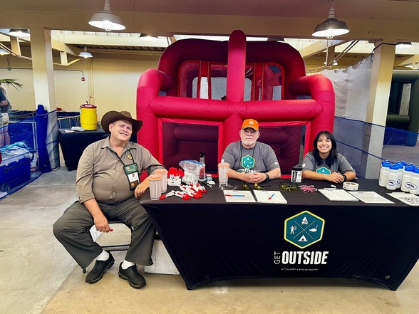 Instructors man an expo table