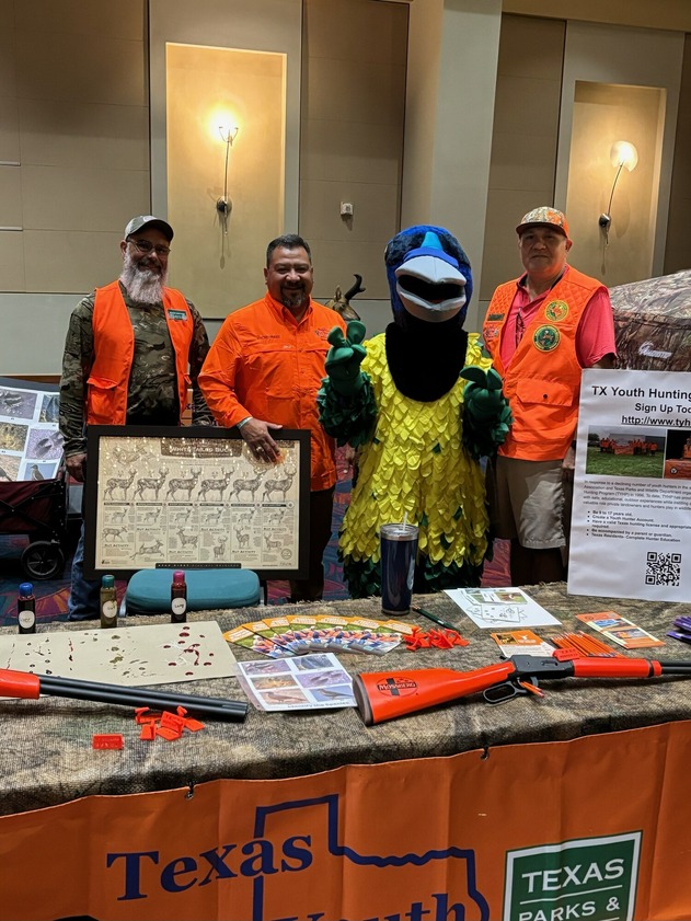 Instructors posing with bird mascot