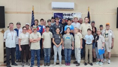Class pic of students against wall