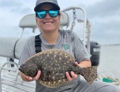 TPWD employee holding flounder