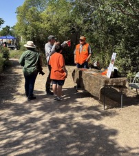 Hunter Ed instructor talking to festival goers by educational display