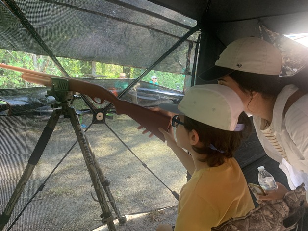 Hunter Ed student looking out of a hunting blind
