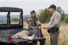 game warden chats with hunter with deer harvest, link