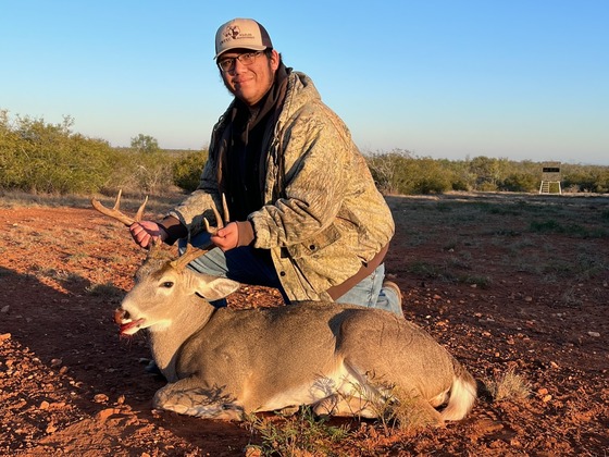 Student hunter posing with his deer