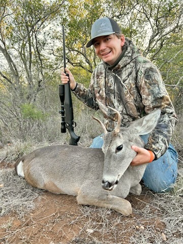 Student hunter posing with his deer