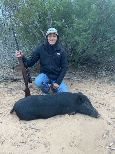 Student hunter posing with his hog
