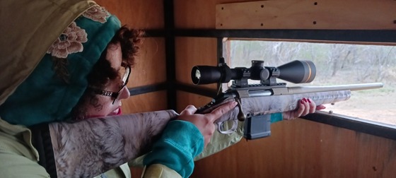 Student hunter taking aim with rifle